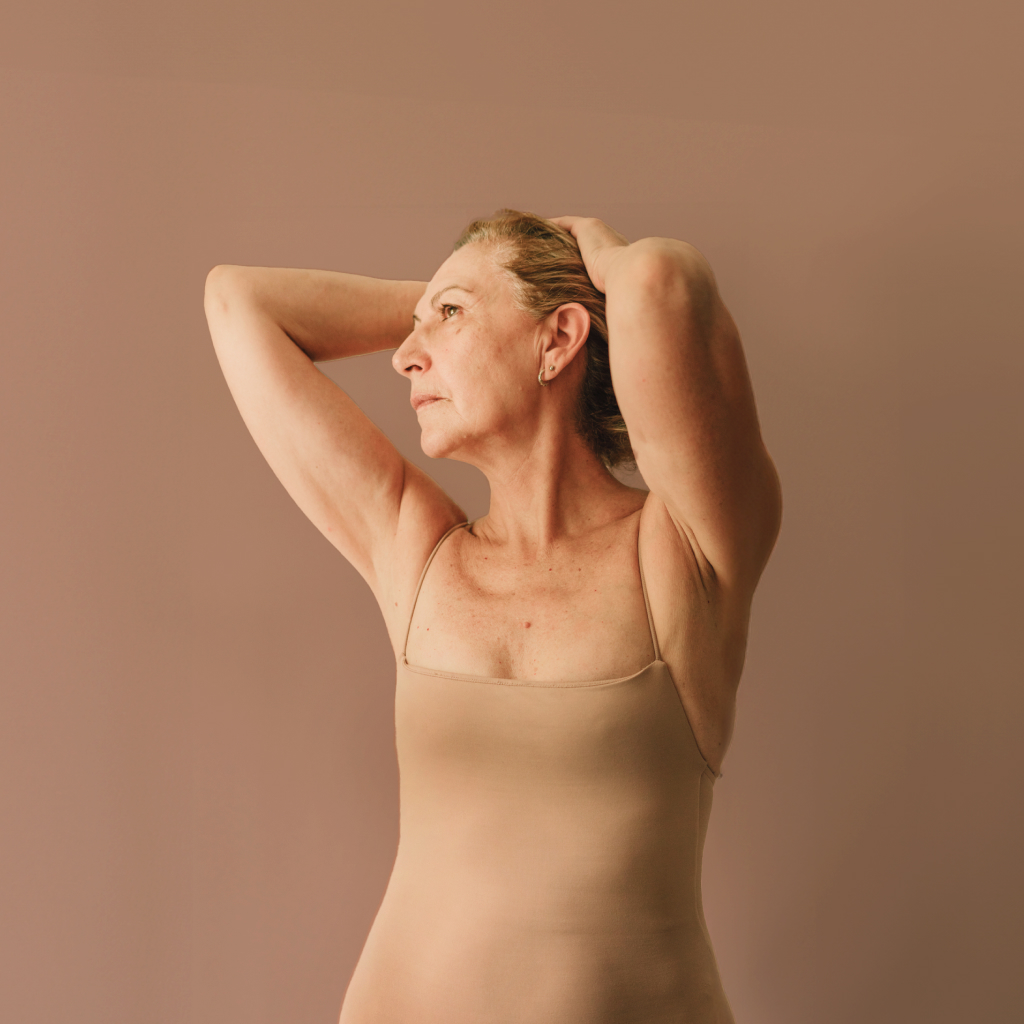 women wearing nude body suit against beige background